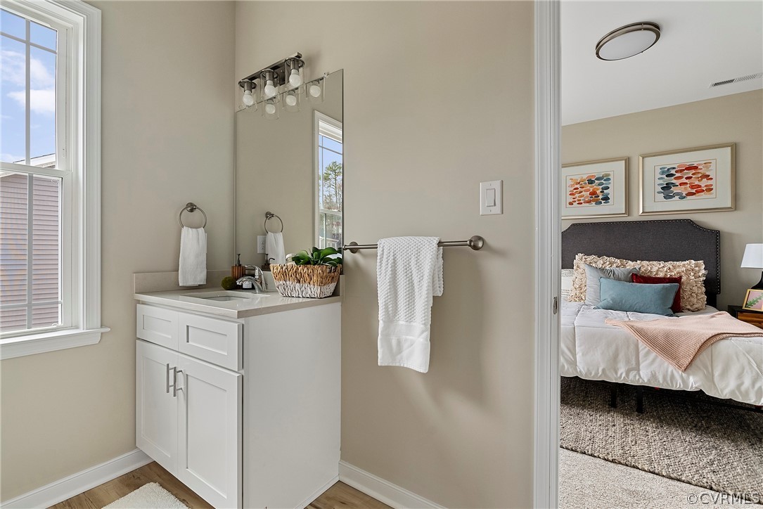 Bathroom vanity beside a bright bedroom
