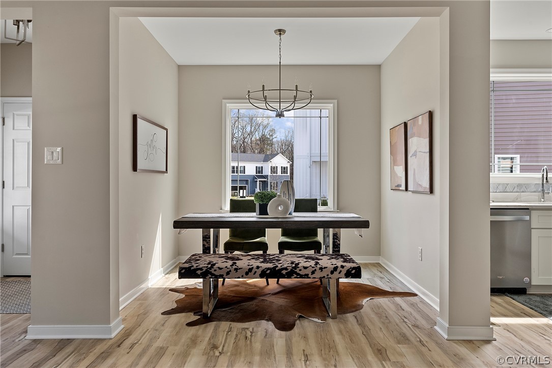 Dining room framed by a wide opening beside the kitchen