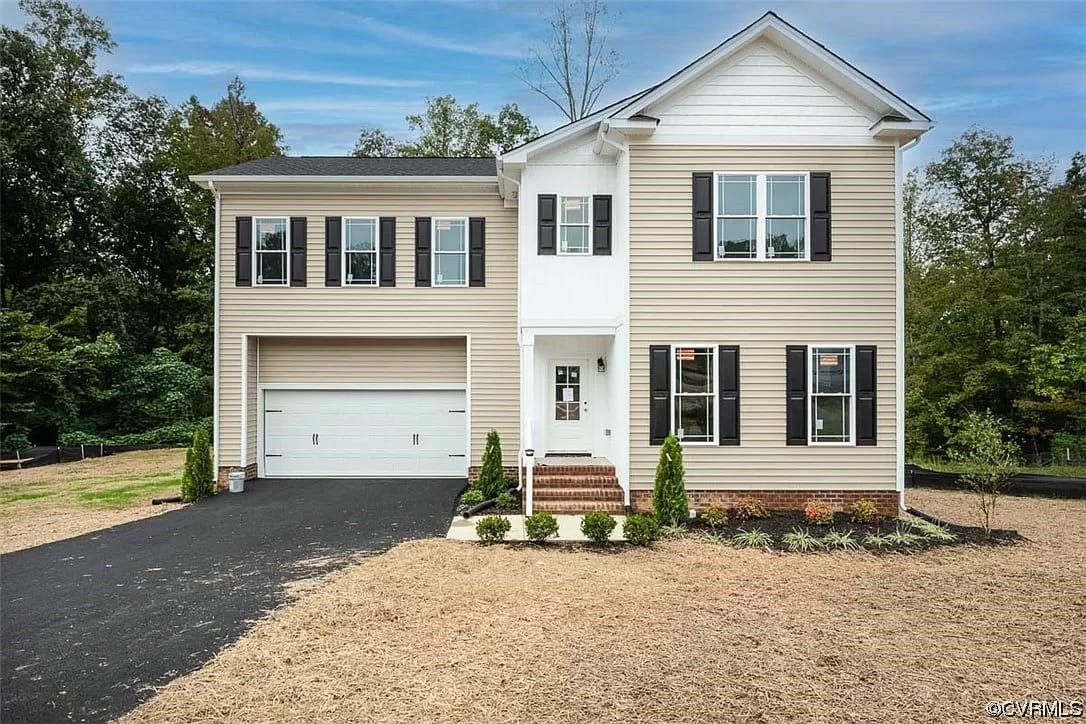 Completed beige and white two-story home with black shutters and attached two-car garage
